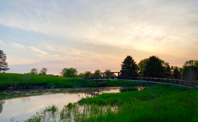 view of golf course at sunrise